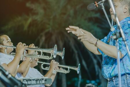 KANCHANABURI-THAILAND, April 12 : Unidentified Male student with friends blow the trumpet with the band for performance on stage at school on april 12,2019 in Kanchanaburi, Thailand.のeditorial素材