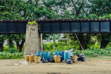 The area that dumped garbage under The Bridge of the River in Kanchanaburi, Thailand. pollution garbage waste, lots of junk dump, plastic garbage waste is environment pollution.の写真素材