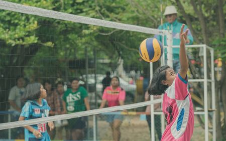 KANCHANABURI THAILAND - JULY 18 :   Unidentified female students play volleyball at the public park on July 18,2018  in Kanchanaburi, Thailandのeditorial素材