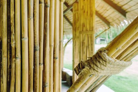 Many bamboo bindings are tied together with hemp ropes to be used as pole for resting cottage. Selective focus on hemp ropes.の写真素材