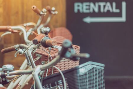 Row of parked vintage bicycles bikes for rent in front of the resort. Selective focus.