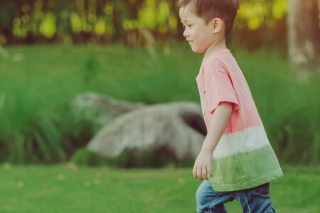 KANCHANABURI THAILAND - OCTOBER 28 : Unidentified  kid enjoy with little ball on green field at Village Farm To CafÃ© on October 28,2018 in Kanchanaburi, Thailand.のeditorial素材