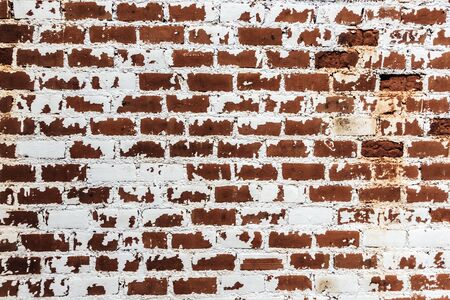 Background of old grunge brick wall texture with peeling plaster.の写真素材
