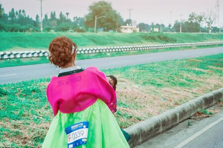KANCHANABURI THAILAND - October 6 : Unidentified Thai women in traditional Korean national costumes run and take photography on the city road on October 6,2019 in Kanchanaburi, Thailandのeditorial素材
