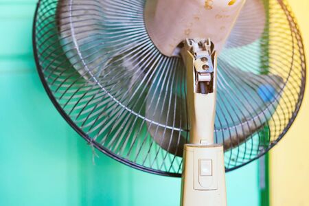 Close up to the old plastic joints of the electronic fan damaged and broken with a blurred...