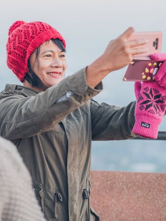 LAMPHUN THAILAND - DECEMBER 9 :  Unidentified tourists taking pictures and selfies while the sunrise on December 9,2019 at Wat Phra Phutthabat Pha Nam in Lamphun, Thailandのeditorial素材