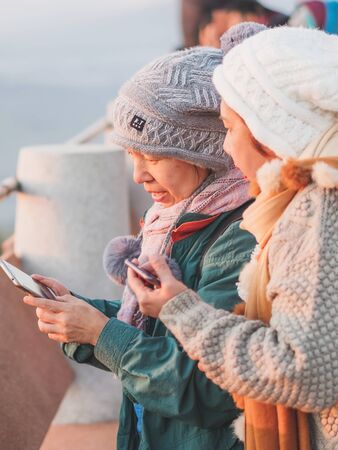 LAMPHUN THAILAND - DECEMBER 9 :  Unidentified tourists taking pictures and selfies while the sunrise on December 9,2019 at Wat Phra Phutthabat Pha Nam in Lamphun, Thailandのeditorial素材
