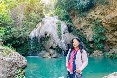LAMPHUN THAILAND - DECEMBER 9 :  Unidentified female tourists taking pictures and selfies on December 9,2019 at Ko-luang waterfall in Lamphun, Thailand.のeditorial素材