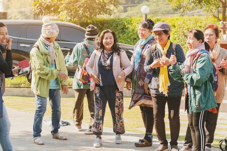 LAMPHUN THAILAND - DECEMBER 9 :  Unidentified female tourists take pictures before boarding the bus on December 9,2019 at Baan Pailyn Resort in Lamphun, Thailand.のeditorial素材