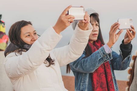 LAMPHUN THAILAND - DECEMBER 9 :  Unidentified tourists taking pictures and selfies while the sunrise...
