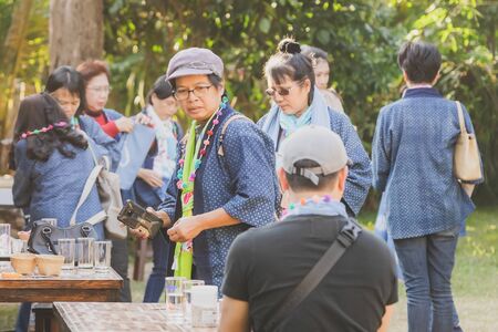 LAMPHUN THAILAND - DECEMBER 12 :  Unidentified Thai female tourists learn to make a necklace from a yarn ball on December 12, 2019 at Karen village in Lamphun, Thailandのeditorial素材