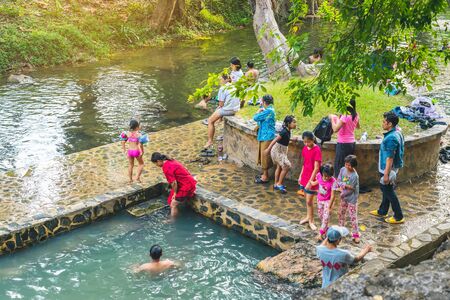 KANCHANABURI, THAILAND - JANUARY 1: Unidentified Asian tourists bathe and soak the body in warm mineral water for good health at Hindad Hotspring on january1, 2020 in Kanchanaburi, Thailand.のeditorial素材