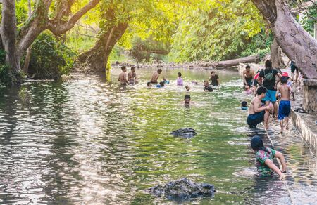 KANCHANABURI, THAILAND - JANUARY 1: Unidentified Asian tourists bathe and soak the body in warm mineral water for good health at Hindad Hotspring on january1, 2020 in Kanchanaburi, Thailand.のeditorial素材
