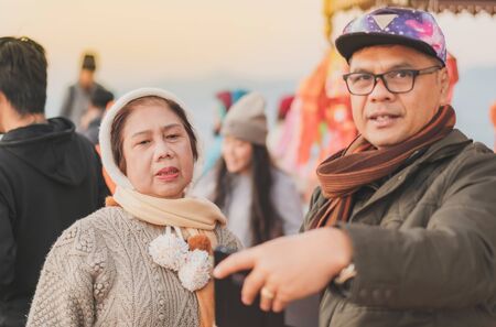 LAMPHUN THAILAND - DECEMBER 9 :  Unidentified tourists taking pictures and selfies while the sunrise on December 9,2019 at Wat Phra Phutthabat Pha Nam in Lamphun, Thailandのeditorial素材