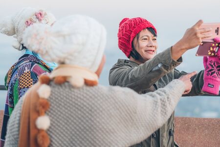 LAMPHUN THAILAND - DECEMBER 9 :  Unidentified tourists taking pictures and selfies while the sunrise on December 9,2019 at Wat Phra Phutthabat Pha Nam in Lamphun, Thailandのeditorial素材
