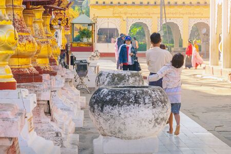 BAGAN-Myanmar, January 21, 2019 : Unidentified tourists make merit and photographing at Shwezigon Pagoda on january 21,2019 in Bagan, Myanmar.のeditorial素材