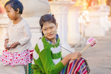 BAGAN-Myanmar, January 21, 2019 : Unidentified tourists make merit and photographing at Shwezigon Pagoda on january 21, 019 in Bagan, Myanmar.のeditorial素材
