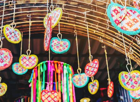Many colorful of fanning woven from bamboo are hung above to decorate the walkway in the annual happiness festival in public park. Selective focus.の写真素材