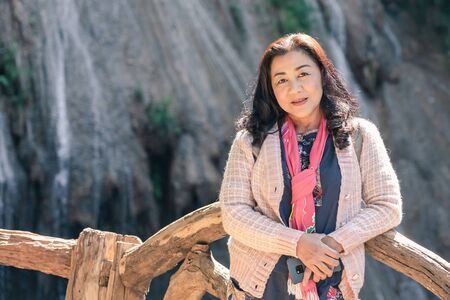 LAMPHUN THAILAND - DECEMBER 9 :  Unidentified female tourists taking pictures and selfies on December 9,2019 at Ko-luang waterfall in Lamphun, Thailand.のeditorial素材