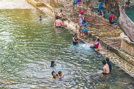 KANCHANABURI, THAILAND - JANUARY 1: Unidentified Asian tourists bathe and soak the body in warm...
