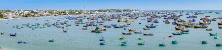 MUI NE, VIETNAM - APRIL 25, 2019 : Panoramic view on  Fishing village and traditional fishing boat with hundreds boats anchored on april 25,2019 in Mui Ne, Vietnam.のeditorial素材