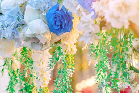 Artificial blue and white flowers decorate the arch as the backdrop in the wedding ceremony. Flowers background. Selective focus.の写真素材