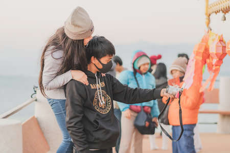LAMPHUN THAILAND - DECEMBER 9 :  Unidentified tourists taking pictures and selfies while the sunrise...