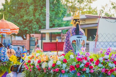 Beautiful with traditionally dressed woman is crowned to be Miss Songkran sit on pickup truck in...