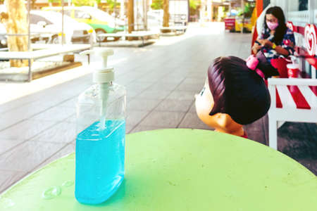 KANCHANABURI THAILAND - MARCH 22 : Coronavirus hand sanitizer gel to wash hands for flu virus prevention for serving customers in front of 7-Eleven convenience store on march 22,2020 in Kanchanaburi, Thailand.のeditorial素材