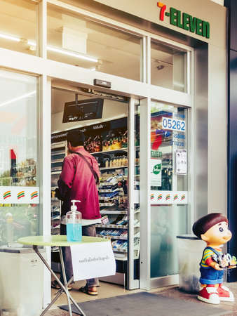 KANCHANABURI THAILAND - MARCH 22 : Coronavirus hand sanitizer gel to wash hands for flu virus prevention for serving customers in front of 7-Eleven convenience store on march 22,2020 in Kanchanaburi, Thailand.のeditorial素材