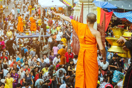 NAKHON PATHOM THAILAND - NOVEMBER 16 :  Unidentified Thai monks bestowed ribbon-flowers on the poor/bystanders as a religious ritual of almsgiving at Wat Phra Pathommachedi on November16,2019 in Nakhon Pathom, Thailandのeditorial素材