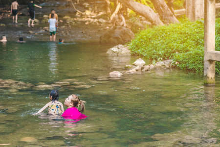 KANCHANABURI, THAILAND - JANUARY 1: Unidentified Asian tourists bathe and soak the body in warm mineral water for good health at Hindad Hot Spring on january1, 2020 in Kanchanaburi, Thailand.のeditorial素材