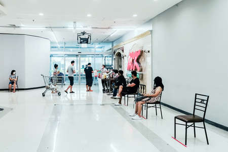 KANCHANABURI/ THAILAND - APRIL 12 2020: Unidentified people order food to take home inside of Tesco Lotus closes due to the corona virus (Covid-19) outbreak but opens only food section at Tesco Lotus. Restaurants set chairs for waiting for the food.のeditorial素材