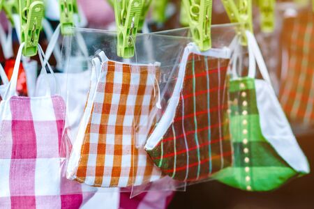 Close up to variety of colorful new face mask handmade sewing from fashion fabric cotton cloth for...