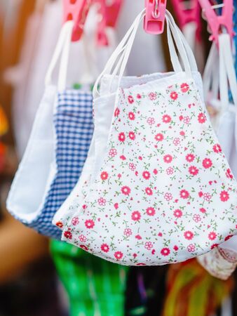 Close up to variety of colorful new face mask handmade sewing from fashion fabric cotton cloth for...