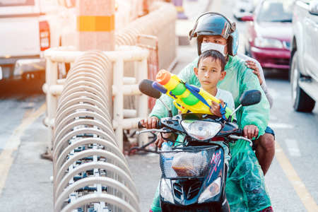KANCHANABURI, THAILAND - APRIL 17,2019: Unidentified people celebrating Songkran by throwing water to each other on road on April 17, 2019 in Kanchanaburi, Thailand.のeditorial素材
