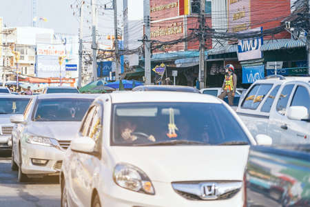 KANCHANABURI, THAILAND - APRIL 17,2019: Unidentified An employees of the traffic road police in uniforms serve on the city street on the road with transport on Songkran festival on April 17, 2019 in Kanchanaburi, Thailand.のeditorial素材