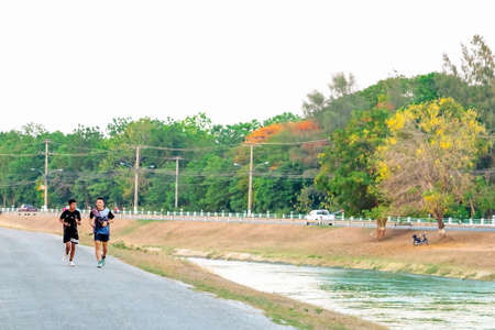 KANCHANABURI/THAILAND-MAY 7,2020 : Unidentified Thai sportive people jogging for good health on road...