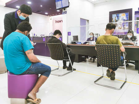 KANCHANABURI THAILAND-MAY 2,2020: The atmosphere of transactions with the bank during the spread of the Corona virus(Covid-19) at Siam Commercial Bank on May 2,2020 in Kanchanaburi,Thailand.のeditorial素材