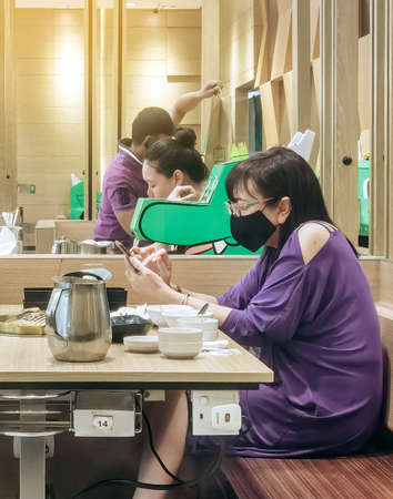 KANCHANABURI,THAILAND-JUNE 1,2020 : Eating with social distancing to prevent the spread of the Corona virus (Covid-19) at Barbecue plaza restaurant in Robinson department store.のeditorial素材