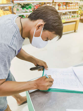 KANCHANABURI, THAILAND-MAY 31,2020: All people must register their identity using a QR code or registration book before shopping to prevent the spread of Corona virus(Covid-19) at Tesco Lotus.のeditorial素材