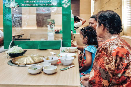 KANCHANABURI,THAILAND-JUNE 1,2020 : Eating with social distancing to prevent the spread of the Corona virus (Covid-19) at Barbecue plaza restaurant in Robinson department store.のeditorial素材