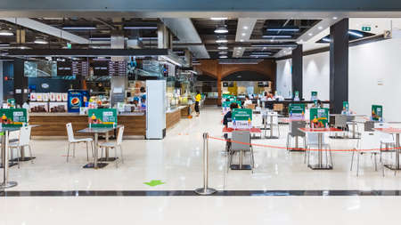 KANCHANABURI, THAILAND-MAY 26,2020: View of Food Park after reopening with sparse people and apart table during social distancing policy due to COVID-19 pandemic at Robinson Department store.のeditorial素材