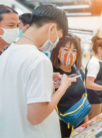 KANCHANABURI,THAILAND-JUNE 20,2020: Unidentified customers choose to order food from menu in front of the restaurant before into the restaurant to eating at MK restaurant in Robinson department storeのeditorial素材