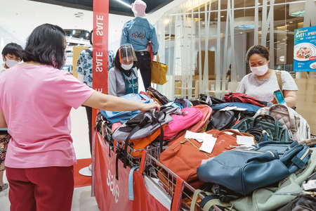 Kanchanaburi, Thailand - June 21,2020: unidentified cashier and customers wear protective masks to protect against coronavirus (Covid-2019) and shopping at the Robinson Department Store.のeditorial素材