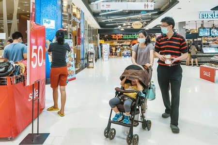 Kanchanaburi, Thailand - JUNE 21, 2020: Unidentified customers wear a protective mask to prevent the Corona virus (Covid-2019) and shopping at the Robinson Department Store.のeditorial素材
