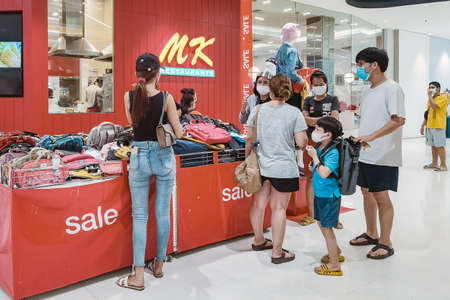 Kanchanaburi, Thailand - June 21,2020: unidentified cashier and customers wear protective masks to protect against coronavirus (Covid-2019) and shopping at the Robinson Department Store.のeditorial素材