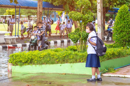 Kanchanaburi,Thailand-JULY 2,2020:Thai students wear various medical masks to prevent themselves from Coronavirus(Covid-19)in time after school and going back home after rain stopped at KTR school.のeditorial素材