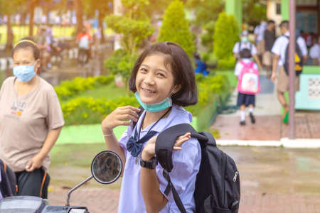 Kanchanaburi,Thailand-JULY 2,2020:Thai students wear various medical masks to prevent themselves from Coronavirus(Covid-19)in time after school and going back home after rain stopped at KTR school.のeditorial素材