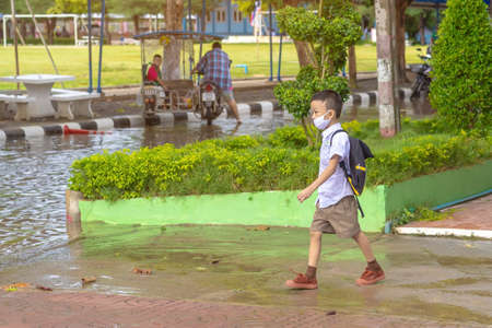 Kanchanaburi,Thailand-JULY 2,2020:Thai students wear various medical masks to prevent themselves from Coronavirus(Covid-19)in time after school and going back home after rain stopped at KTR school.のeditorial素材